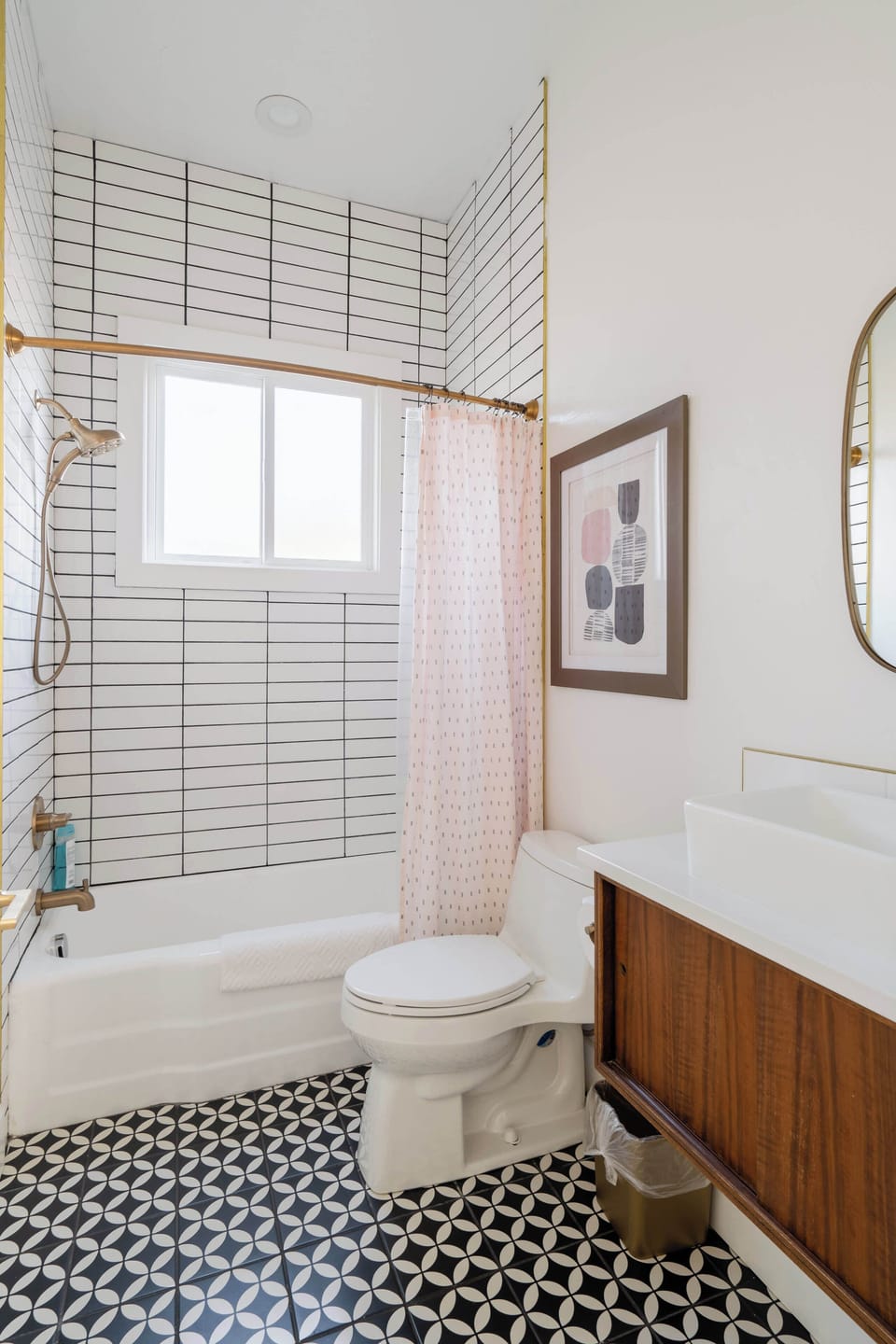 Bathroom with a vessel sink, toilet and bathtub with shower.