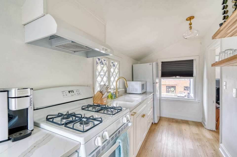 Kitchen with gas range, coffee maker, and fridge.