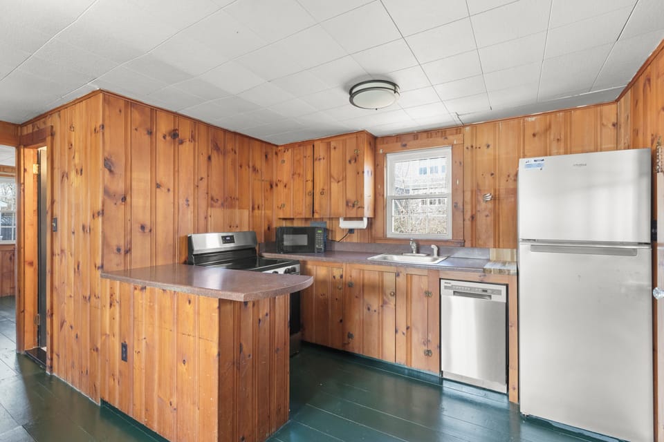 Kitchen is fully stocked with dishes and cookware.