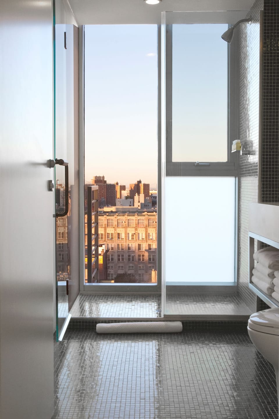 Shower, designer toiletries, hair dryer, towels