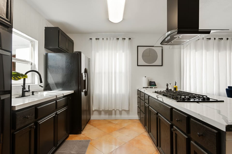 Kitchen with pots, pans, olive oil, salt, pepper and many more seasonings. 