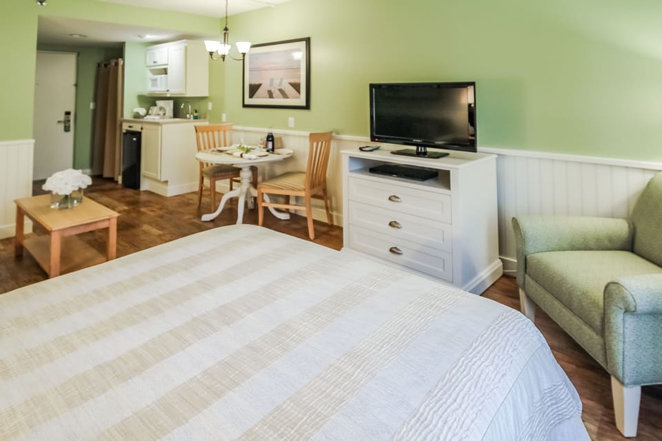 This cozy studio features a Murphy bed, sleeper sofa, and kitchenette equipped with a mini fridge, microwave, toaster, and coffee maker, perfect for couples or small families.