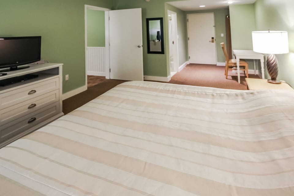 The serene bedroom boasts a comfortable king bed and a cozy ambiance, ensuring restful nights during your stay in this charming retreat.