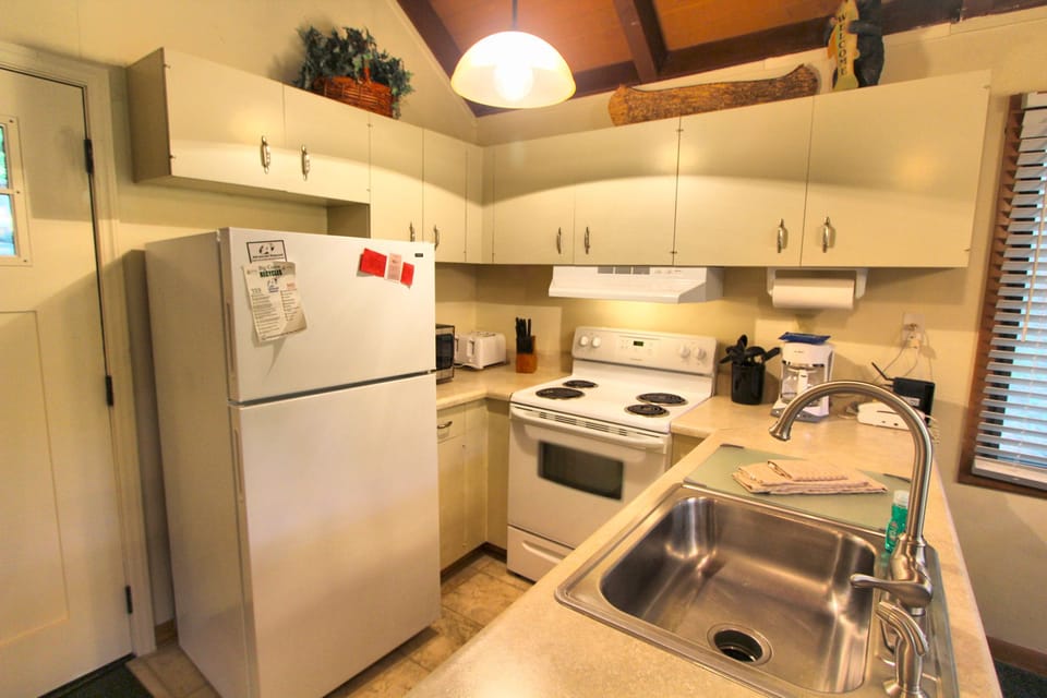 The fully equipped kitchen in this cozy retreat is perfect for family meals, with all essentials at your fingertips for culinary creations.