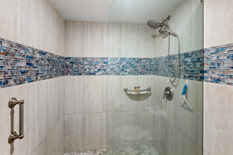 Walk-in tile shower with a separate vanity area