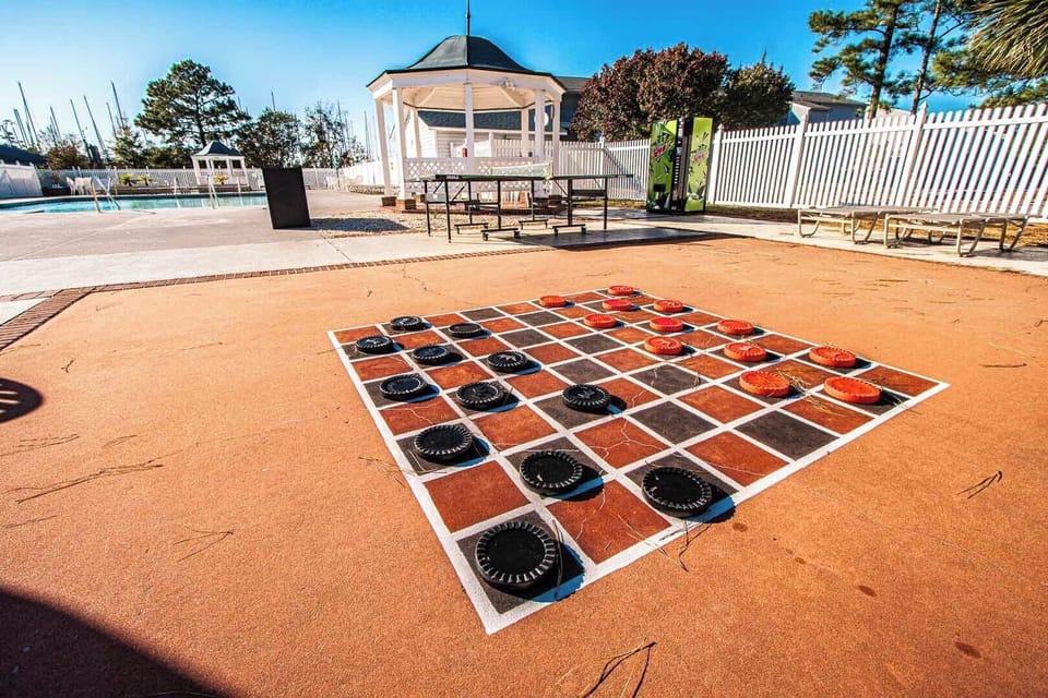 Engage in friendly competition with family on the large checkers board, nestled near the outdoor pool and surrounded by beautiful landscaping.