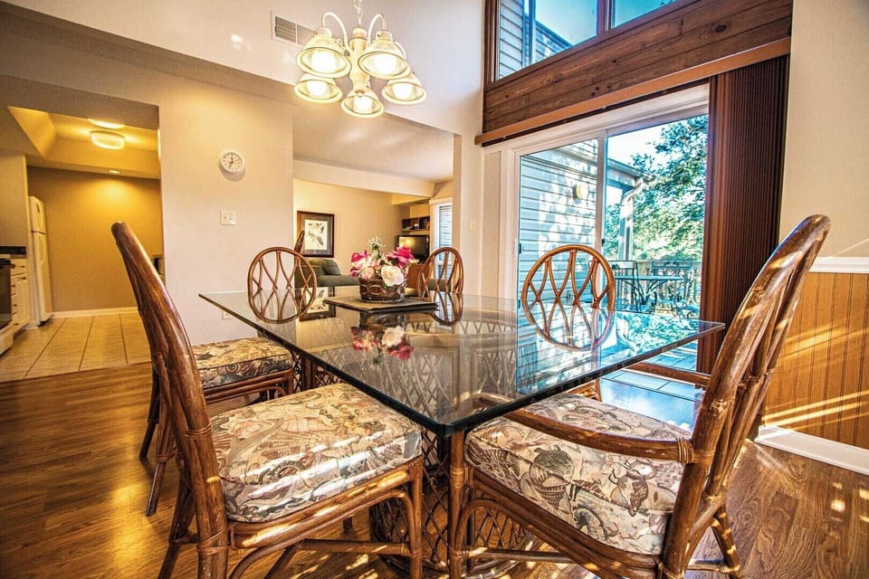 The bright dining area boasts a stylish table set for family meals, enhancing your dining experience with views of the outdoors.