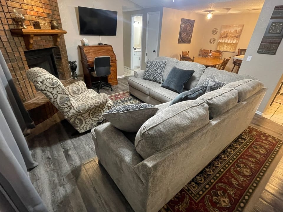 Living room with sectional sofa and rocker/recliner.
