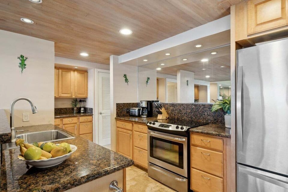 Spacious kitchen offering granite surfaces, modern appliances, and abundant storage for a stress-free stay
