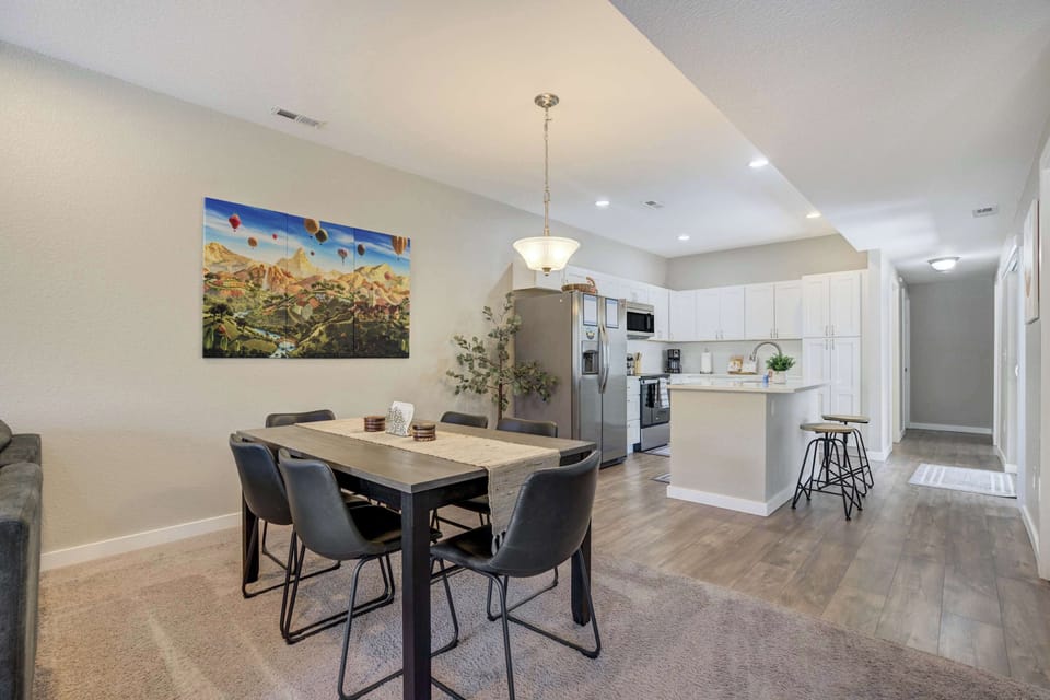 The open dining area connects seamlessly to the living room, offering a modern table and comfortable seating for relaxed meals and memorable conversations.








