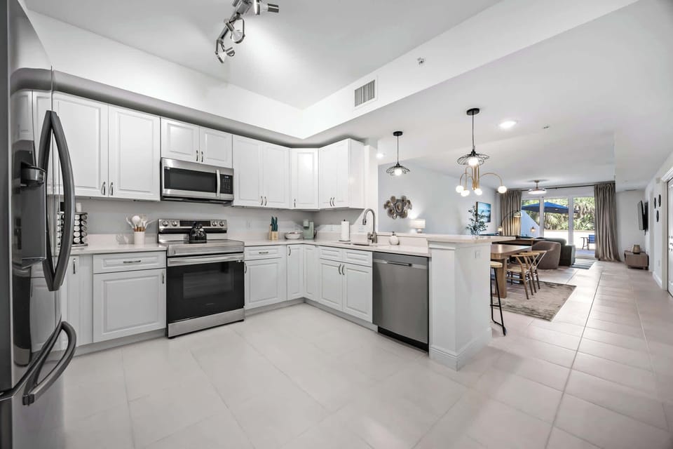 Modern kitchen with stainless steel appliances and open access to the living area.