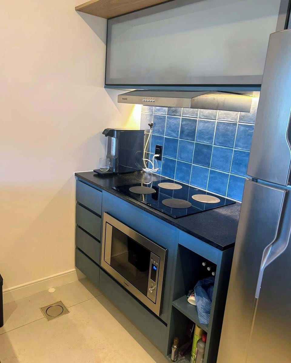 Kitchen fully stocked with cooking&eating utensils. The kitchen also includes a coffee maker & a full set of pots & pans.