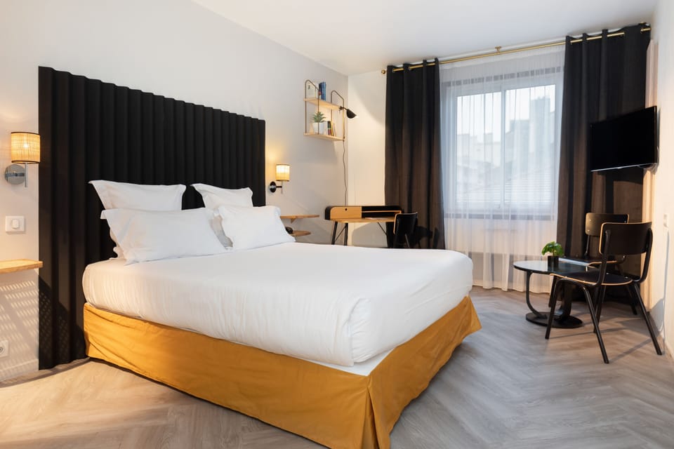 Premium bedding, desk, laptop workspace, blackout drapes