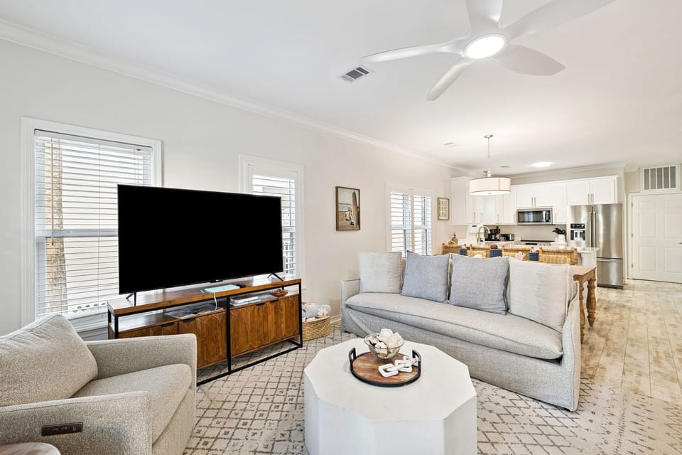 Sink into plush sofas while your favorite shows play on the large TV, with the modern kitchen just steps away for snacks.