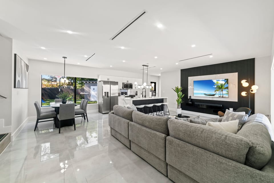 This elegant living room combines bright white walls with soft gray tones
