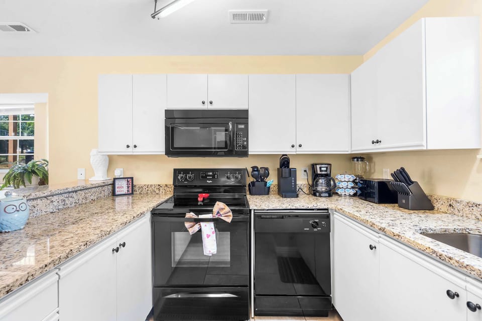 The airy kitchen offers ample space & all the comforts of home