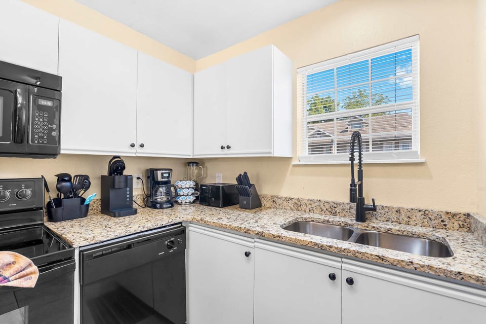 The airy kitchen offers ample space & all the comforts of home