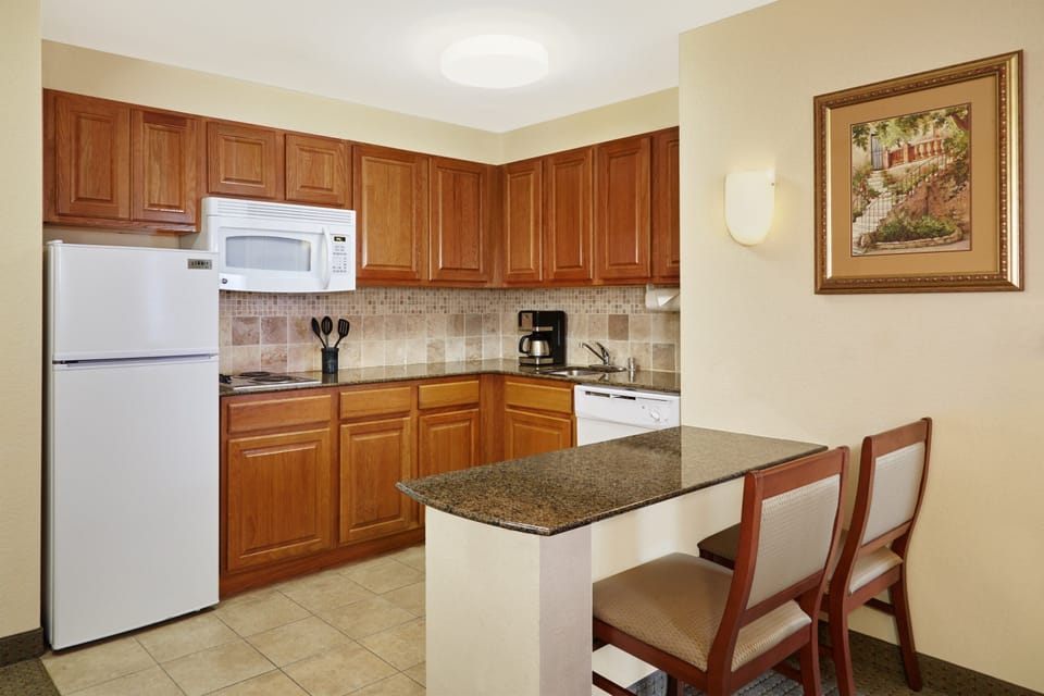 Cook a small meal in the kitchen.