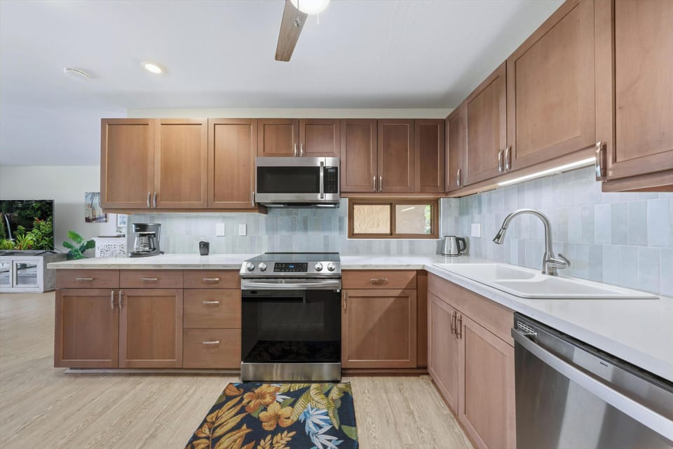 Cook your favorite meals in a fully equipped kitchen with modern appliances, ample counter space, and warm wood cabinetry—everything you need to feel right at home.