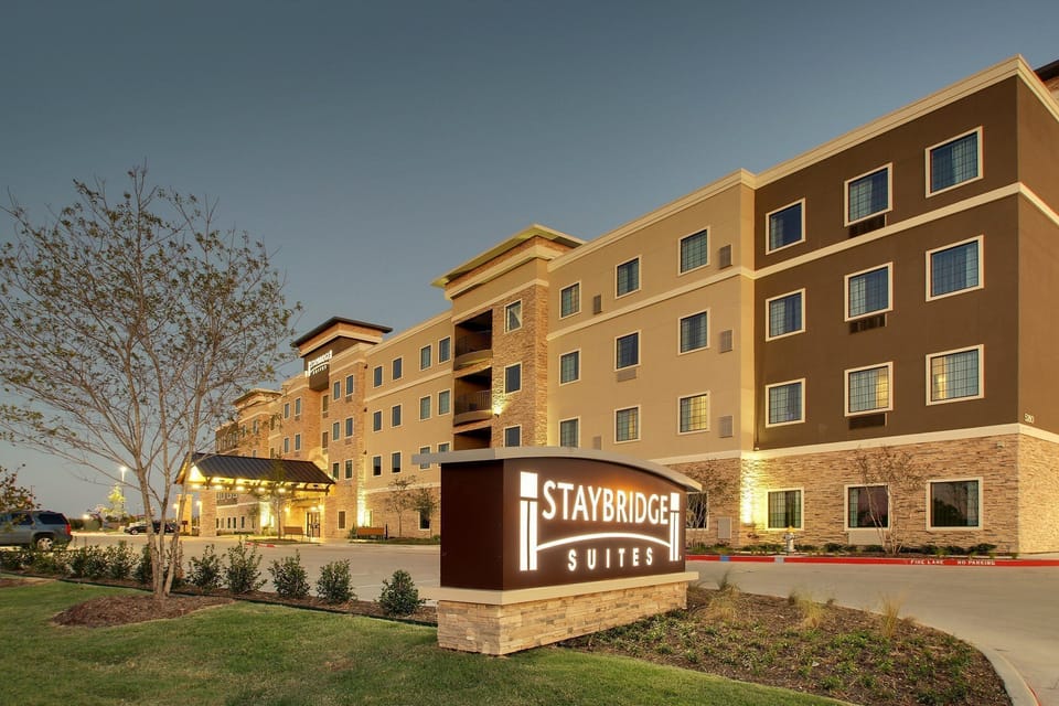 Modern building facade surrounded by manicured landscaping.
