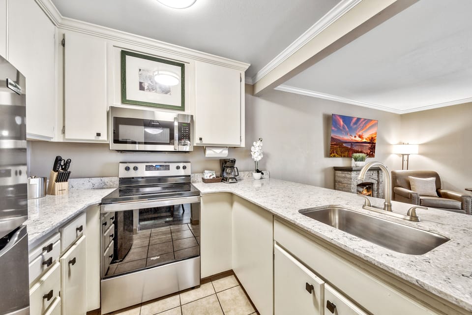 A well-equipped kitchen with modern appliances, sleek countertops, and an open layout, perfect for preparing meals with ease.