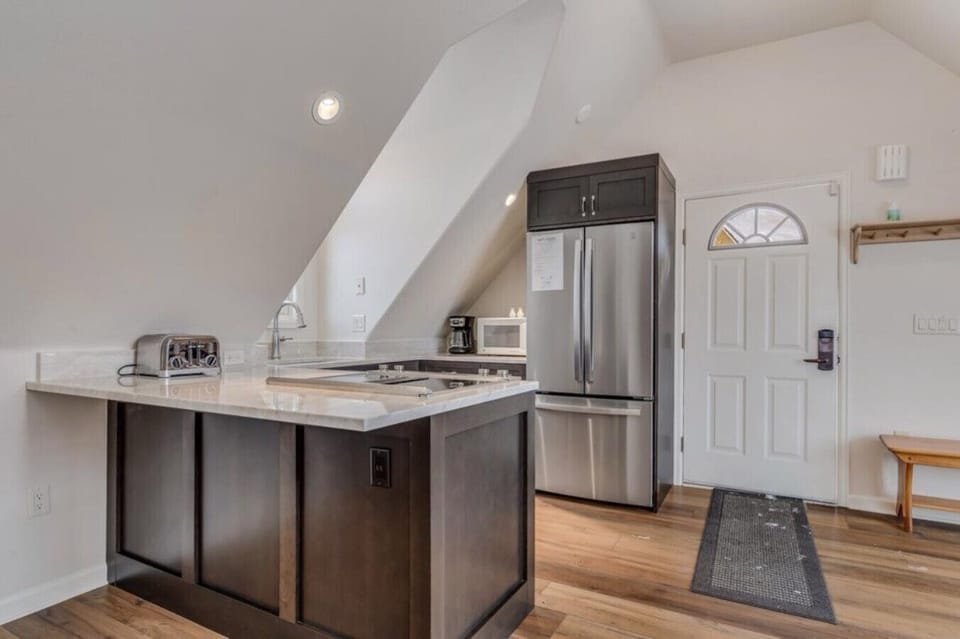 This apartment features a full kitchen with refrigerator, stove top, oven, dishwasher and microwave.