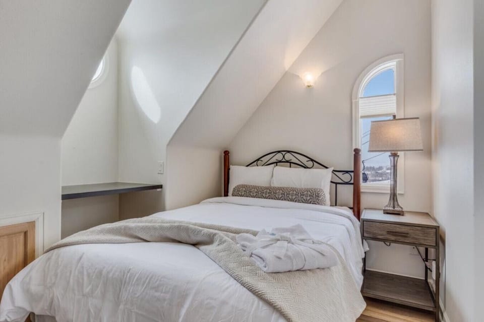 This cozy bedroom has a queen bed and attached bathroom.