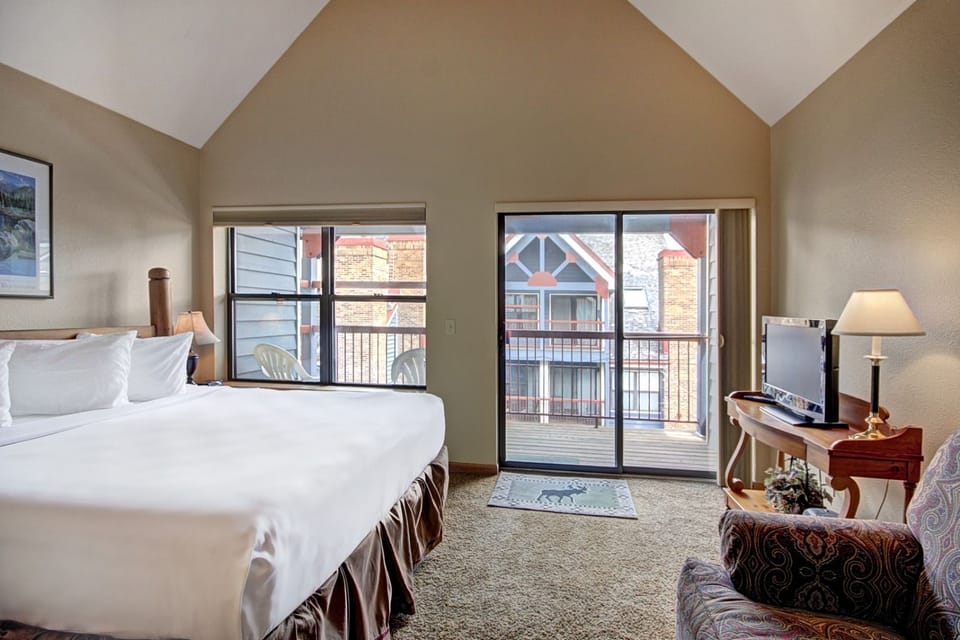 Restful bedroom sanctuary with vaulted ceilings and picture windows framing the views.