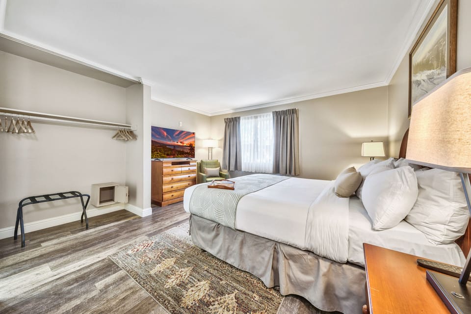 A serene and inviting bedroom with soft lighting, plush bedding, and a cozy atmosphere—perfect for a restful night’s sleep.