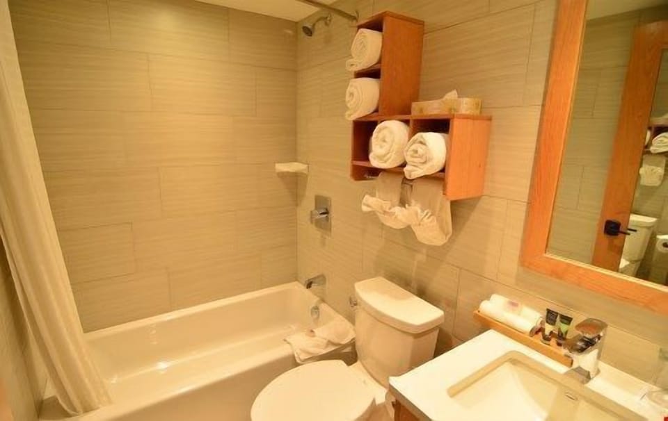The spacious and bright bathroom features a lovely shower-tub combination.