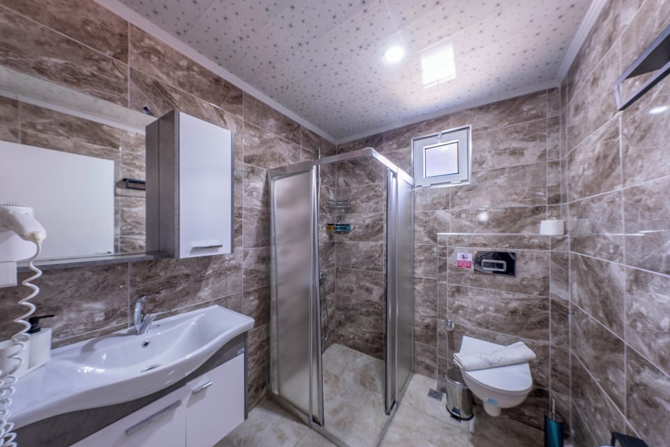 Shower, hair dryer, slippers, towels