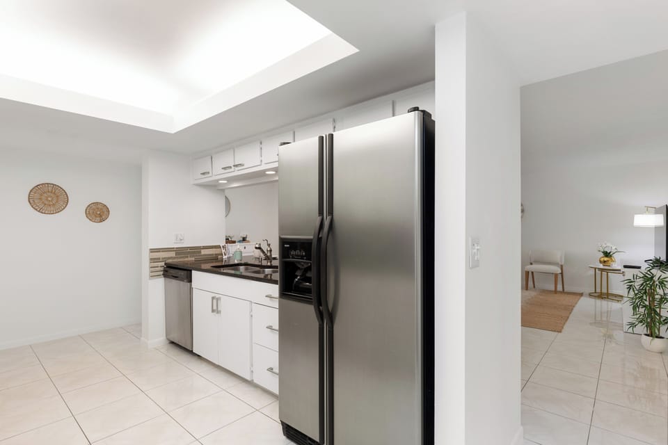 Sleek kitchen area featuring clean design and bright overhead lighting