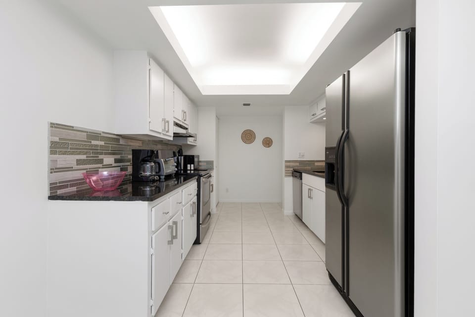 Compact kitchen w/ modern appliances and task lighting for easy prep