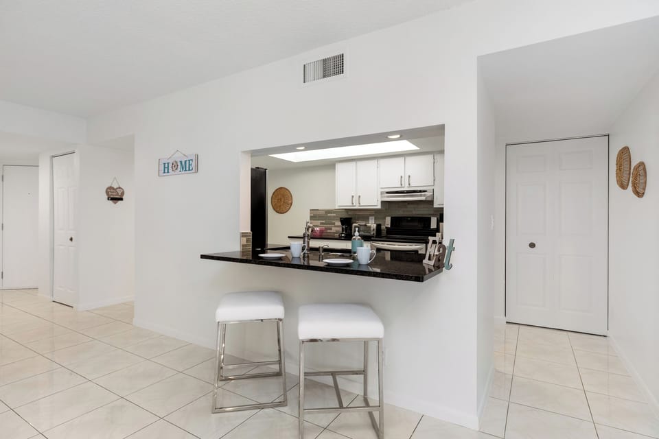 Sleek kitchen counter with bar stools, ideal for casual meals or morning coffee