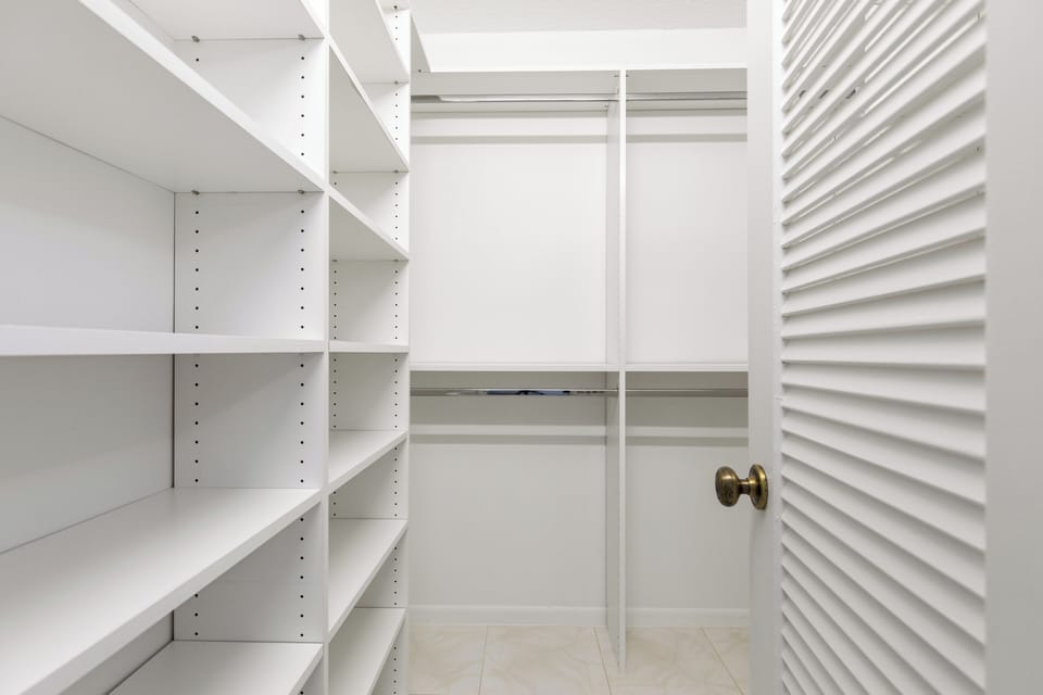 Neat stock-style room with shelving, organized supplies, and simple layout