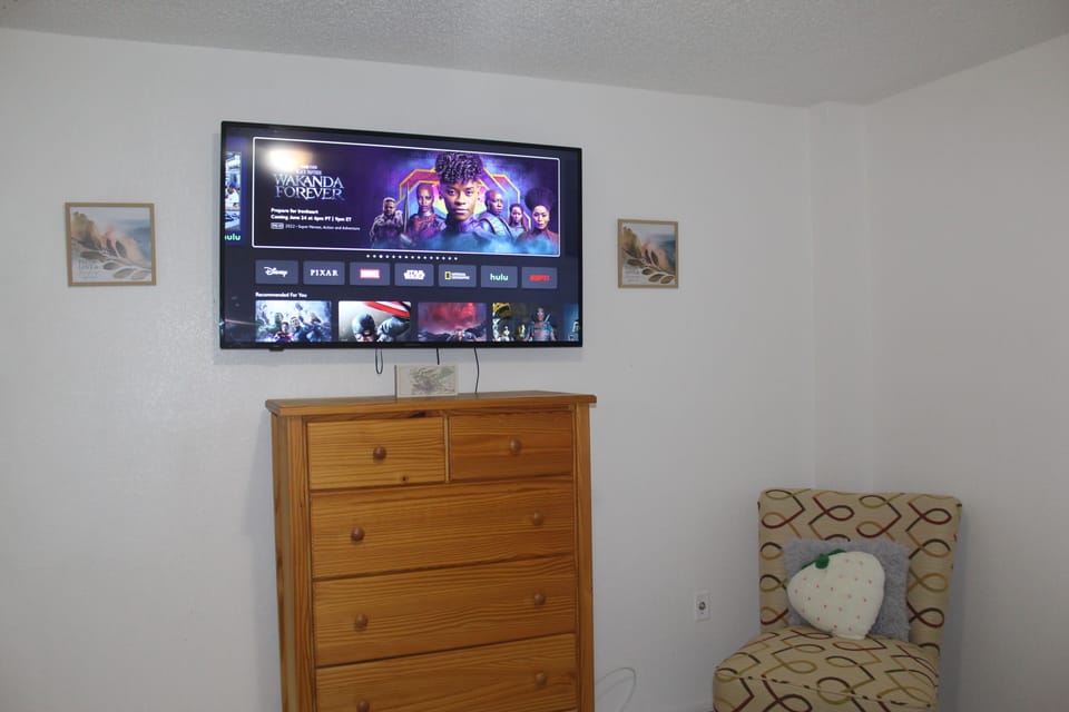 Second bedroom with attached bathroom and 55" smart tv
