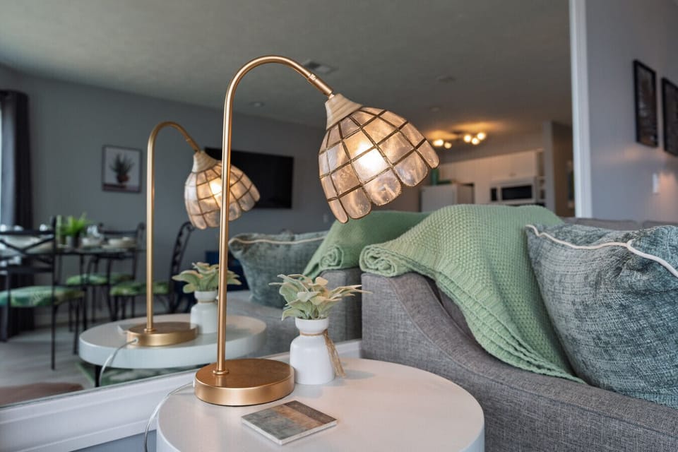 Elegant side table with a stylish lamp and greenery to elevate the room`s ambiance ✨