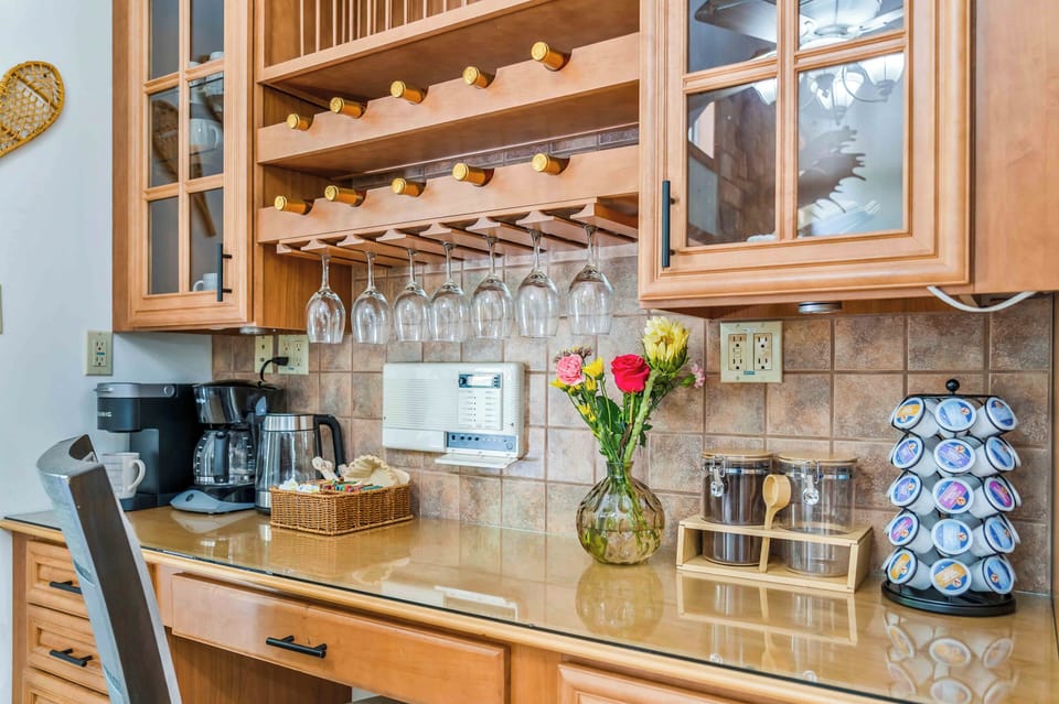 Start your mornings with a fresh cup from the fully stocked coffee bar, and wind down with a glass of wine from the built-in rack. With cozy seating, glassware ready to go, and both Keurig and drip coffee options, this stylish nook is perfect for your daily rituals—day or night.