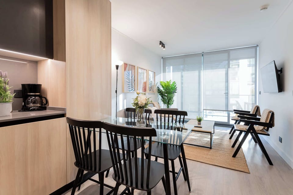Bright and modern living space with a stylish dining area, perfect for relaxing or entertaining during your stay.