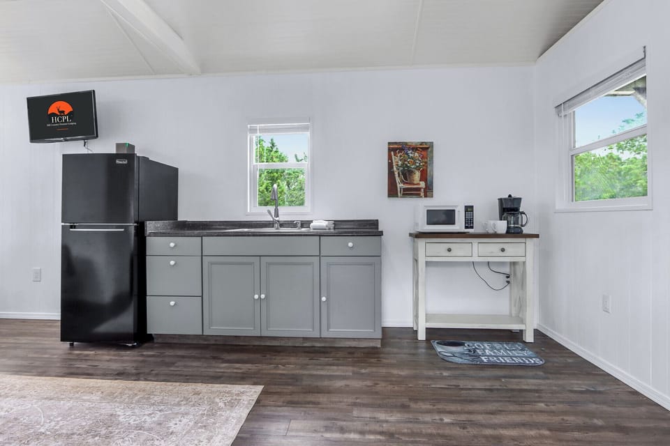 The unit has a kitchenette with refrigerator, microwave, and coffee pot.
