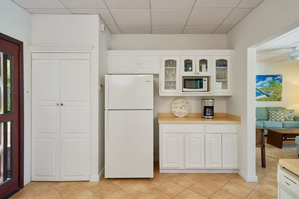 The cupboard next to the large fridge-freezer houses a washing machine and tumble dryer for your convenience