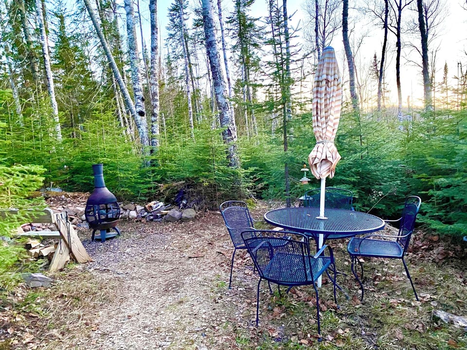 Ole’s private outdoor area area has a table for eating and a fire pit