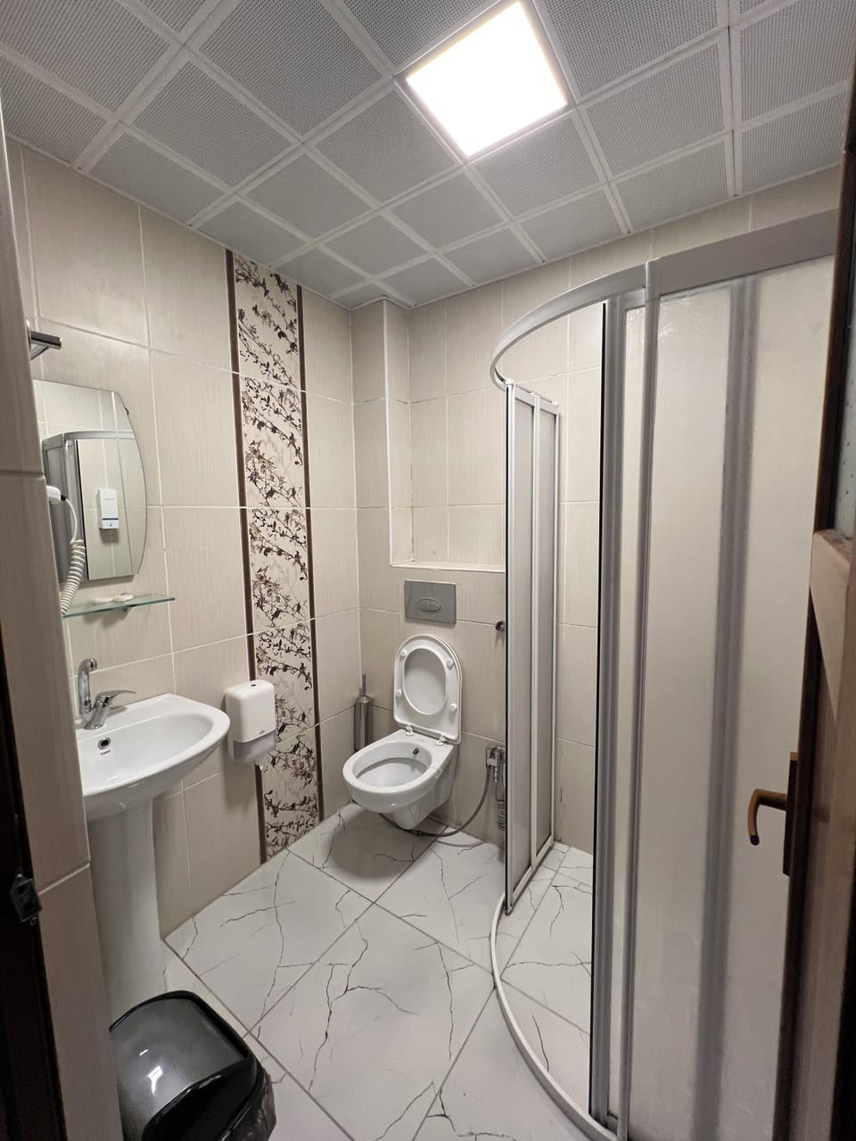 Shower, hair dryer, slippers, towels