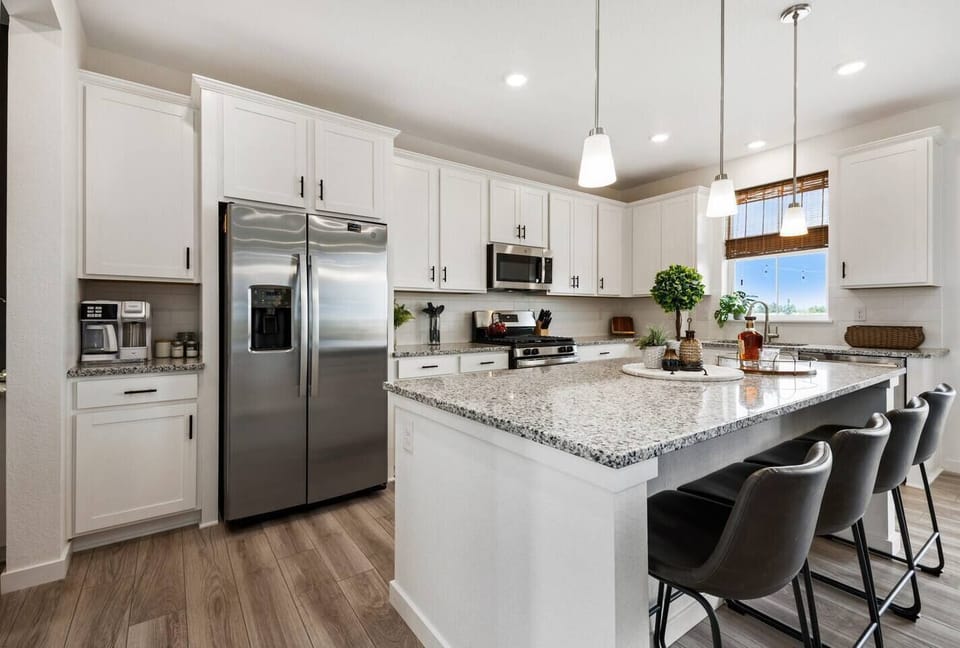 Cook, connect, and entertain in the spacious kitchen featuring granite countertops, stainless steel appliances, and a large island perfect for prepping meals or gathering with friends and family. Just steps from the dining area and living room, it’s the heart of the home
