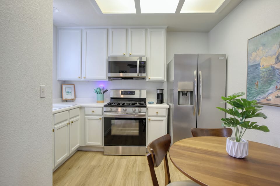 The fully equipped kitchen has a refrigerator, stove and oven, microwave, k-cup coffee maker, and dish ware—everything you need to whip up meals or enjoy a fresh cup of coffee before heading to the beach.