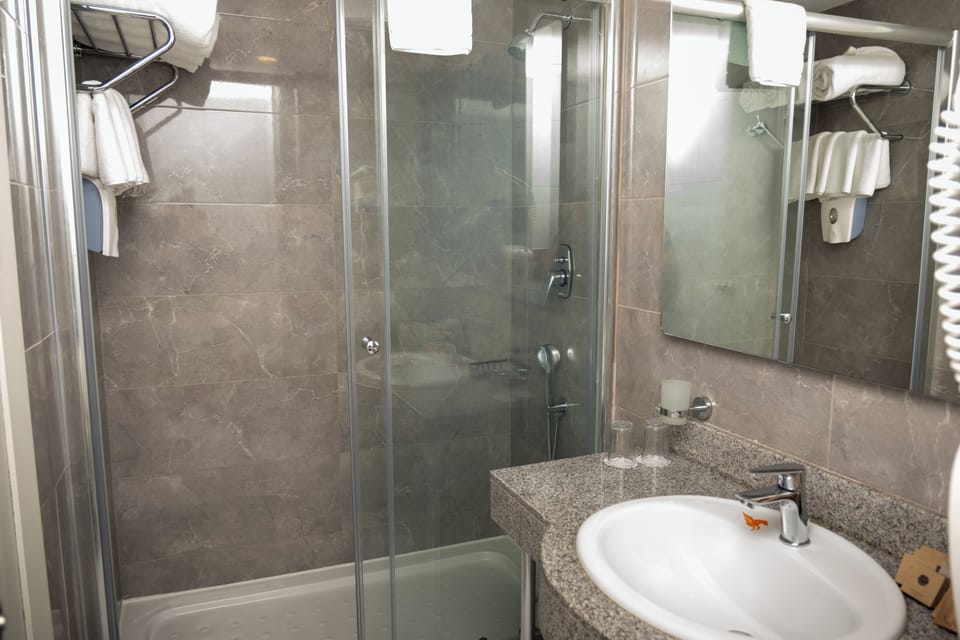 Shower, eco-friendly toiletries, hair dryer, towels