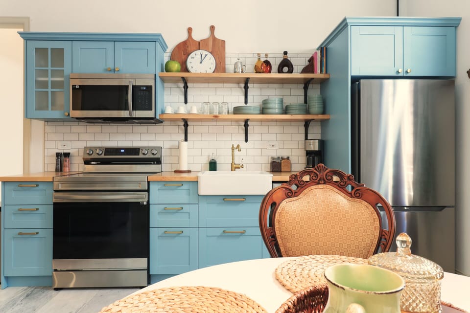 Compact but complete kitchen includes dishwasher and oven.