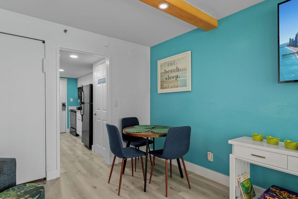 A cozy dining area with seating for four, perfect for casual meals after beach days or late-night snacks.