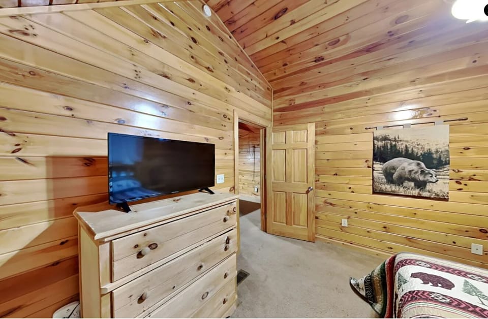 Upstairs bedroom with TV and storage chest