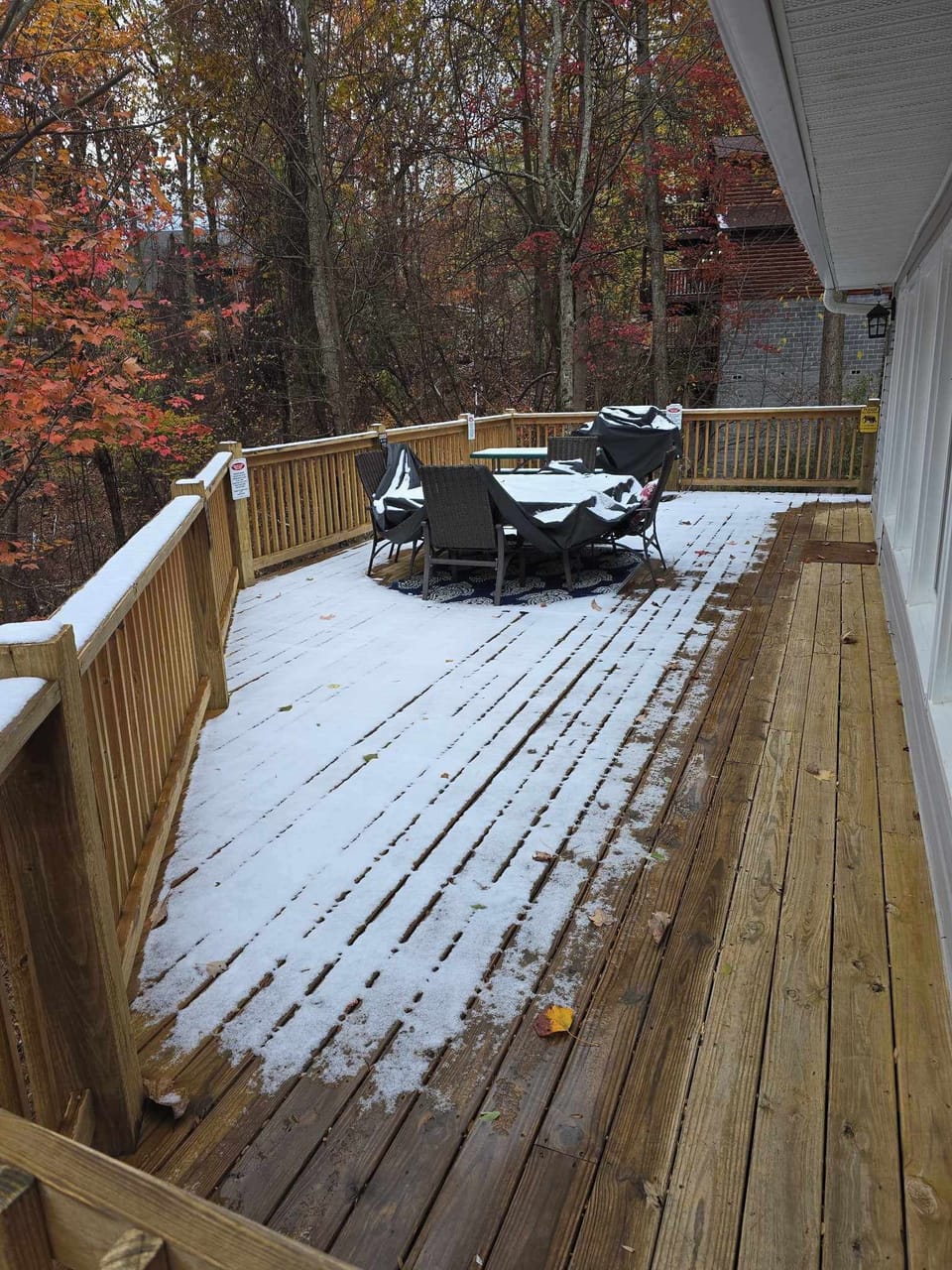 Partial wrap around deck overlooks a small forest
Outdoor table/chairs